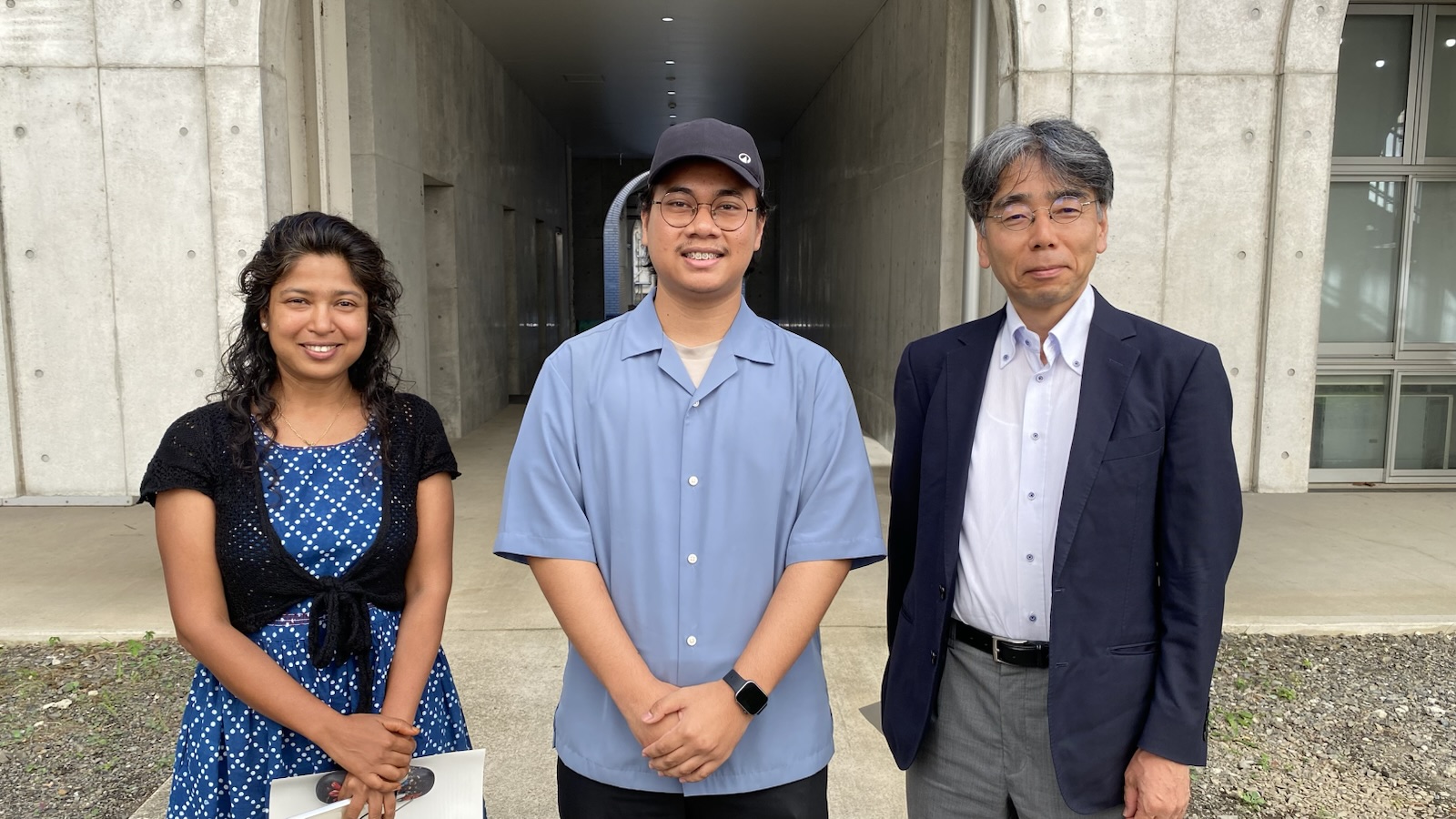 Dr. Soma Purkait, Hasbi and Prof. Yuichiro Taguchi standing together outside a building